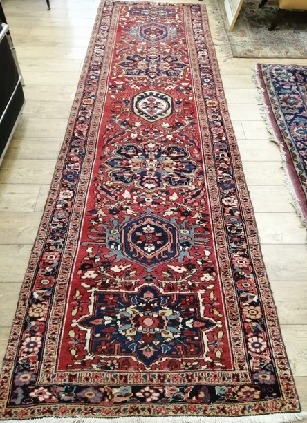 A Karajah red ground runner 105 x 370cm